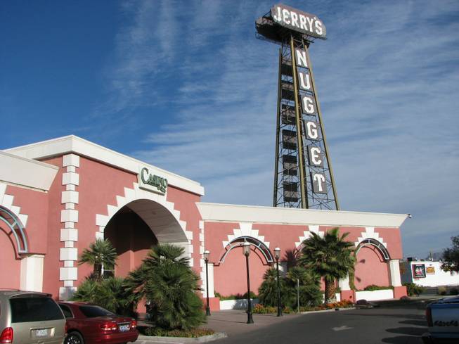 The oil derrick of Jerry's Nugget casino towers over the building in this photo. Jerry's Nugget was founded on the site of the Town House Bar in 1964. The owners soon bought the Bonanza Club, a casino on an adjacent property in 1968. The Bonanza was the original home of the oil derrick now at Jerry's Nugget, it was once the tallest sign in Las Vegas.