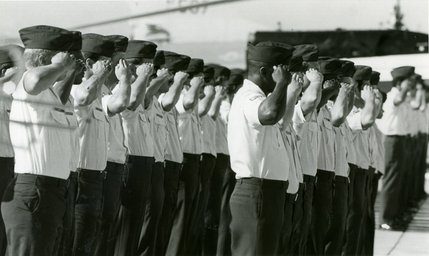Officers stand and salute at Nellis Air Force Base on Sept. 24, 1985. The 14,000-acre base currently holds nearly 12,000 military personnel and civilians and contains more squadrons than any other Air Force base in the world.