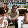 Matt Fox, 22, talks to party-goers about drink discounts during his Nightclub Management class' semester-end project, a pool party at MGM Grand's Wet Republic. 