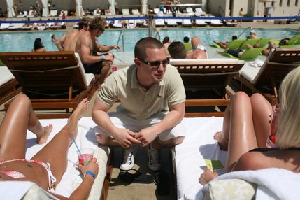 Matt Fox, 22, talks to party-goers about drink discounts during his Nightclub Management class' semester-end project, a pool party at MGM Grand's Wet Republic. 