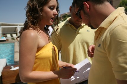 Nightclub Management student, Cheryl Martin, reviews some notes with classmates as they run their semester-end project, a pool party at MGM Grand's Wet Republic. 