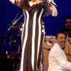 An elevator causes Bette Midler to rise above stage during her 