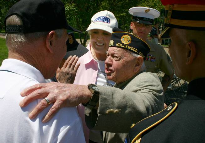 In this photo provided by Lincoln Highway National Museum, World War II Veteran Mickey Rooney, 87, talks with Medal of Honor recipient Captain Thomas J. Hudner, USN while his wife Jan and others looks on during the National Memorial Day Celebration in Washington D.C. Monday May 26, 2008.
