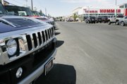 The lots are full of vehicles at Towbin Hummer on Sahara, where the economy model gets 13 mpg.