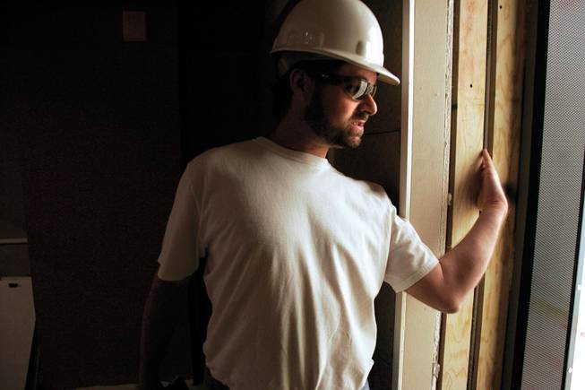 Dan Grimes, UNLV TV's manager of instructional production and engineering, demonstrates how walls are soundproofed in a recording studio in the new academic center, scheduled to open in August. 