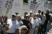 Construction workers walk the picket line Tuesday outside CityCenter, where accidents on the job site have killed six of their counterparts. 