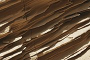 Sandstone in the walls of "Double Negative" has eroded. The Los Angeles museum that owns the work is not conserving it because the artist prefers nature reclaim the land.