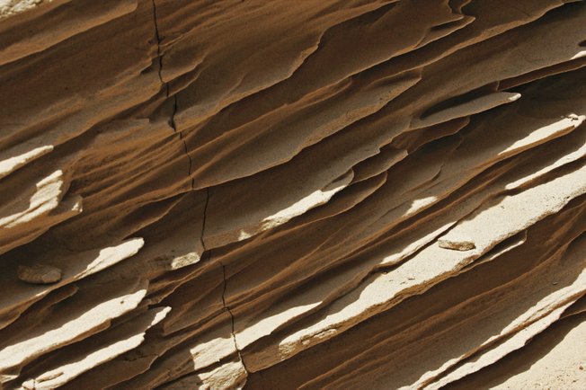 Sandstone in the walls of "Double Negative" has eroded. The Los Angeles museum that owns the work is not conserving it because the artist prefers nature reclaim the land.
