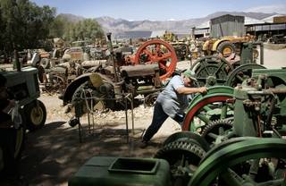 Ron Dahl tries to start a 1958 motor, part of his antique farm equipment collection on his property Oasis Ranch in Amargosa Valley Friday, June 5, 2009. 