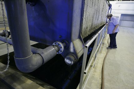 Kelvin Spendlove monitors a machine that compresses solid waste into 