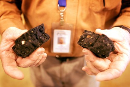 Bill Shepherd, manager of plant operations, holds de-watered solid waste, also called a 
