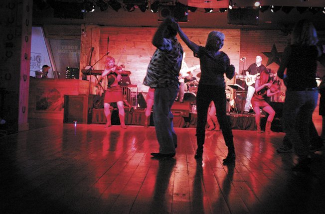 Marty and Ellie Koppel, who have been married for 47 years, dance at Dixie's. Spokesman Joe Donato says country music is perfect for Hooters. "We wanted to create something that would bring people in. Country music and Hooters are a good tie in."