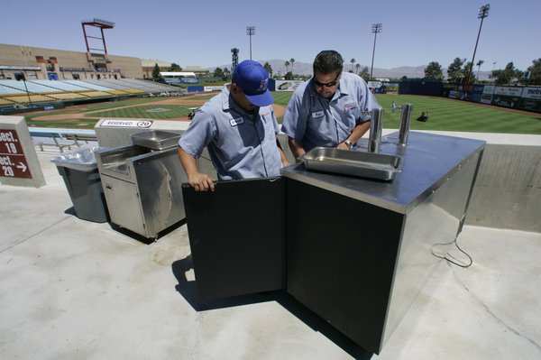 Nevada Beverage special events team members Gabriel Salazar, left, and ...