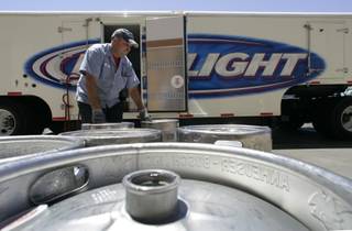 Bob Roik, a Nevada Beverage draft sales rep, picks up empty kegs of beer at Cashman Field.