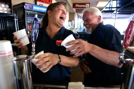 Bartenders Kelly Miller, left, and Blu Sandford joke around while serving 12 oz. cups of Budweiser and Bud Light during Dollar Beer Night at Cashman Field for the Las Vegas 51's game against the Portland Beavers. Miller and Sandford have been tending bar together at 51's games for four years.

