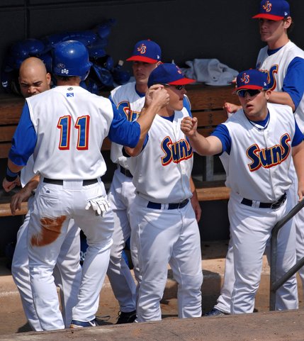 Jacksonville Suns' Anthony Raglani, left, receives congratulations from teammates after scoring from second base. 