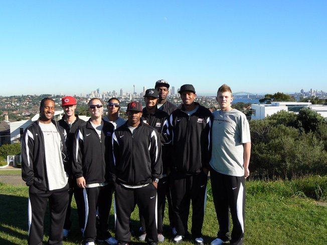 Members of UNLV's men's basketball team pose for a photo in front of downtown Sydney during their tour of Australia