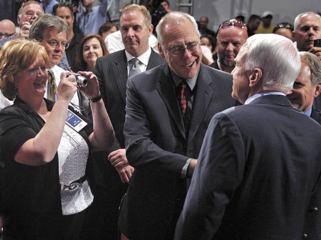 A supporter snaps a photo of John McCain after the senator's speech Wednesday at UNLV. McCain issued a challenge to automakers to come up with a "clean car," promising a consumer tax credit of up to $5,000 for cars with low carbon emissions. He has offered a $300 million prize for developing a next-generation car battery.