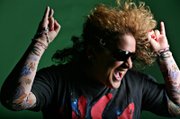 Angela Corvello of Las Vegas poses for portraits before her first air guitar contest this weekend. The Air Guitar Championships will be held Sunday at Harrah's Carnaval Court. Parts of costumes are being sent to her from across the country.