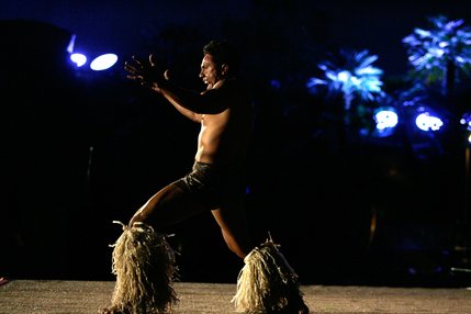 Samoan dancer Foi Tuitama, left, performs a fire knife dance during the Imperial Luau held poolside at the Imperial Palace's Shangri-la pool. 