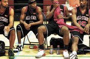 Stars players, from left, Julius Johnson, Eddie Shelby, Demario Butler and Elliott McGee rest during halftime of the Racers game. Most of the teams in the league are, like Elgin, from the region around Chicago or from the Pacific Northwest.
