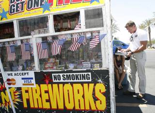 Henderson fire inspector Bradley Stasik conducts an inspection of a fireworks stand before giving the OK to open for business last Saturday.