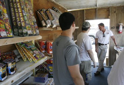 Fire inspector Bradley Stasik inspects this fireworks stand in Henderson last Saturday before giving his OK for it to open for business.