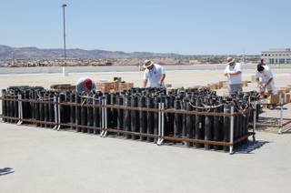 Pyrotechnicians of Grucci's of New York prepare for Friday's Fourth of July firework display atop the Sunset Station Casino in Henderson. The show at Sunset is one of five Station Casino shows done by Grucci's this Forth of July. 