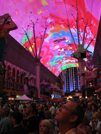 Members of the crowd stand and watch as the Viva Vision displays patriotic images set to classic American songs.