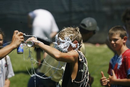 Austin Lelles, 13, tries to defend himself as he is sprayed with silly-string during the 60th annual Damboree parade in Boulder City.