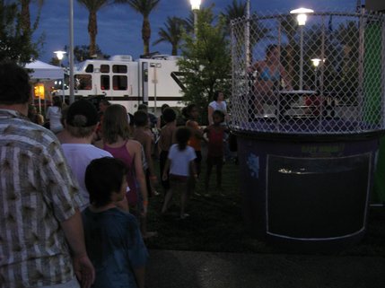 Children young and old wait their turn for the dunk tank during the Fourth of July festivities in downtown Henderson.