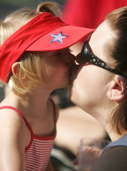 Megan Lick, 21 months, kisses her mother, Tristen, during the Summerlin Patriotic Parade on July 4.  