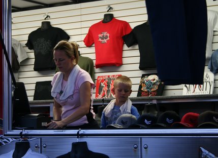 A boy helps his mother sell memorabilia at the Las Vegas Motor Speedway.