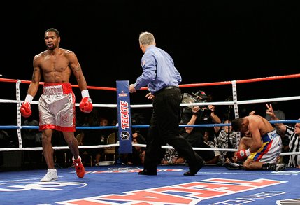 Kendall Holt, left, heads to a neutral corner after knocking down WBO junior welterweight champion Ricardo Torres during their rematch at Planet Hollywood.