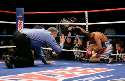 Referee Jay Nady, left, starts a count after WBO junior welterweight champion Ricardo Torres was knocked down by Kendall Holt during their rematch at Planet Hollywood. Holt won the title by KO.