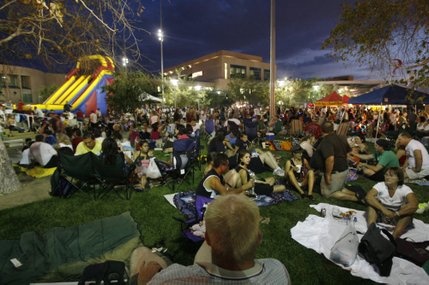 Spectators relax during the celebration at the Henderson Events Plaza.
