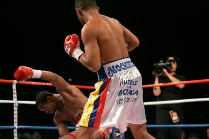 Kendall Holt, left, gets knocked down for the first of two knockdowns by WBO junior welterweight champion Ricardo Torres during their title fight at Planet Hollywood.