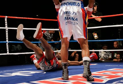Kendall Holt hits the canvas after being knocked down for the first of two knock downs during his fight against WBO junior welterweight champion Ricardo Torres at Planet Hollywood.