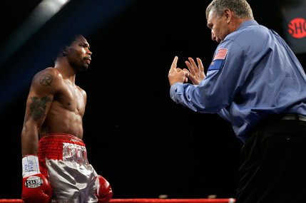 Referee Jay Nady starts a count on Kendall Holt after he was knocked down by WBO junior welterweight champion Ricardo Torres for the second time in the first round of their title fight at Planet Hollywood.