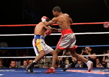 Kendall Holt, right, connects on WBO junior welterweight champion Ricardo Torres during their title fight at Planet Hollywood. Holt came back from two knockdowns to take the title with a first-round KO.