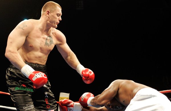 Kaspars Kambala hits Ron Weaver to the ground during their ...