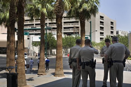 Marshals wait outside the Regional Justice Center to escort Adam 