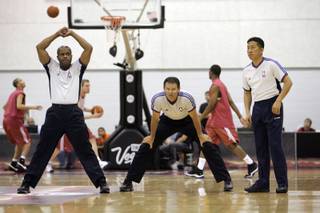 Officials stretch out as they prepare for a NBA Summer League game  between New York Knicks and Cleveland Cavaliers at the Cox Pavilion in Las Vegas on Monday July 14.
