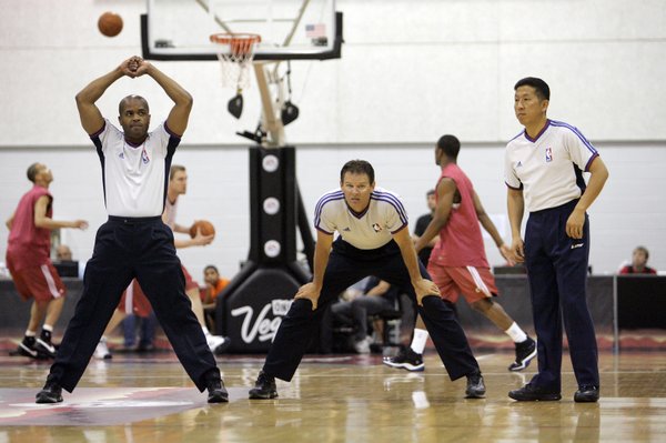 Officials stretch out as they prepare for a NBA Summer ...