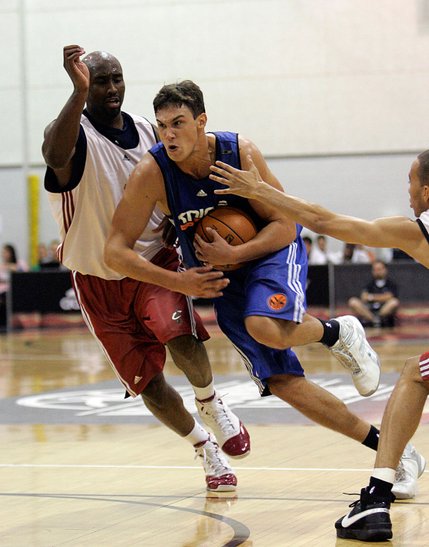 New York Knicks forward Danilo Gallinari, center, tries to drive past Cleveland Cavaliers' Billy Thomas, left, and Yohann Sangare during an NBA Summer League game Monday, July 14 at the COX Pavilion in Las Vegas.