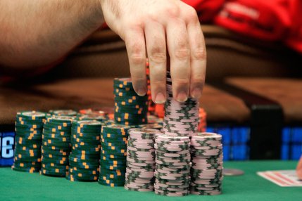 Joe Bishop plays with his chips during one of the two final tables of the WSOP World Championship No Limit Texas Hold 'em event. 