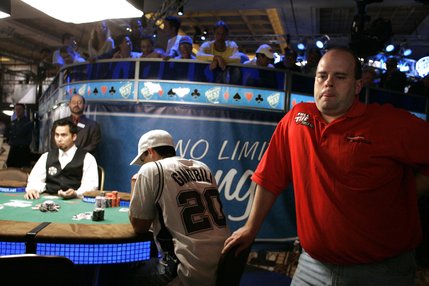 With only 13 players left, Joe Bishop, right, contemplates his next move against Chris Klodnicki, center seated, during the last hand before a dinner break at the WSOP World Championship No Limit Texas Hold 'em event. Both Bishop and Klodnicki were knocked out before the final table was determined, early the next morning.
