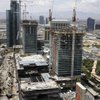 Cranes and construction equipment surround the Cosmopolitan on Monday. The resort's unconventional design places retail on the first several floors and makes the casino accessible from a side entrance. 
