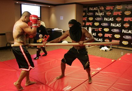 Anderson Silva clowns around, pretending to be a ninja while attacking workout partner Rafael Custodio. 