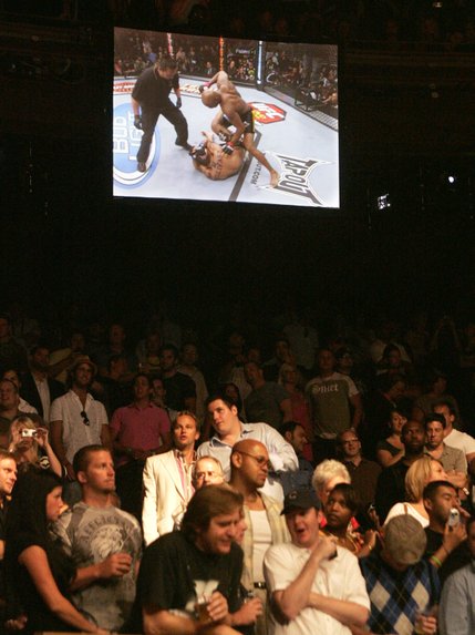 Fight fans watch a replay of Anderson Silva's first round TKO of James Irvin during their UFC bout at the Palms.